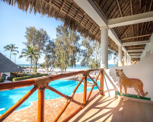 a view from the balcony of a villa with a giraffe on the wall at Kiwengwa Beach Resort in Kiwengwa