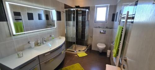 a bathroom with a shower and a sink and a toilet at Villa Kasandra in Kaštel
