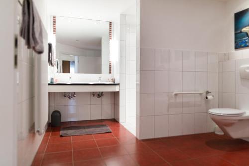 a bathroom with a toilet and a mirror at Ferienhaus Panorama Mosel in Reil