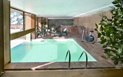 a swimming pool in a house with a patio at Ancolie Chalets De La Vallee D'or - 3 Pièces pour 6 Personnes 84 in Valloire