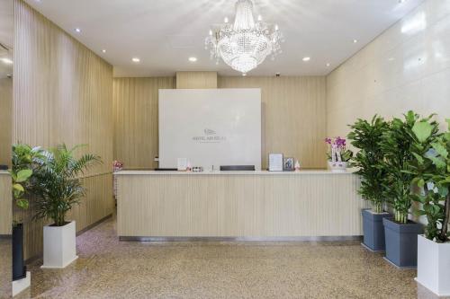 a lobby with a reception desk and potted plants at Incheon Aiport Airrelax hotel in Incheon
