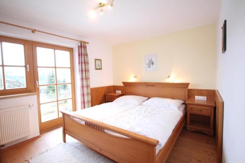 a bedroom with a large bed and a window at Ferienwohnung Königsleiten 37 - Top 1 in Königsleiten