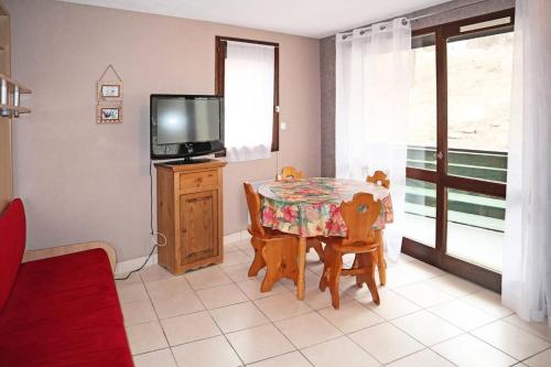 une salle à manger avec une table et une télévision dans l'établissement Résidence Les Flocons - Studio pour 4 Personnes MAE-7324, aux Orres
