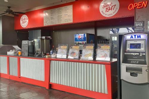 a fast food restaurant counter with a cash register at Skyline Island Colony Hotel in Honolulu