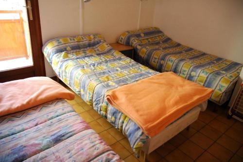 a group of three beds in a room at Résidence Les Alpages - 3 Pièces pour 6 Personnes 74 in Valloire