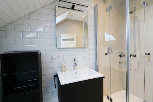 a bathroom with a sink and a shower at Ferienwohnung "Hygge" in Schluchsee in Schluchsee