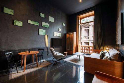 a living room with a couch and a table at Umbral, Curio Collection By Hilton in Mexico City