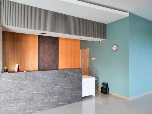 a room with a counter and a clock on the wall at Wikost Premiere Inn Mitra RedDoorz in Plelen