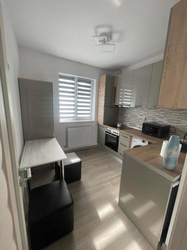 a small kitchen with a counter and a counter top at Luxury Apartment in Piteşti