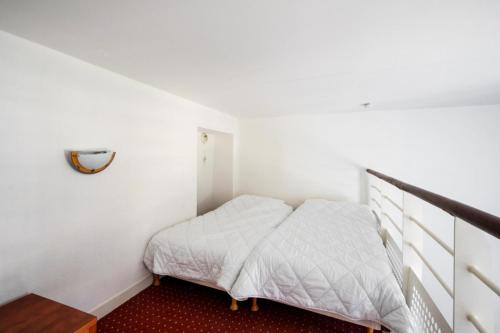 une petite chambre avec un lit et un escalier dans l'établissement Résidence Saint Goustan - maeva Home - Studio 3 personnes Budget - Vue mer MAE-0472, au Croisic