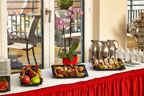 a table with three trays of food on it at HYPERION Hotel Berlin in Berlin