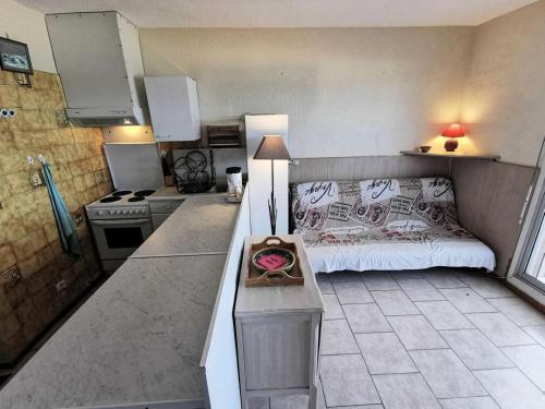 une petite cuisine avec un canapé et une table dans l'établissement Résidence LES NEFS DES SABLES - 2 Pièces pour 5 Personnes 14, à Port-Leucate