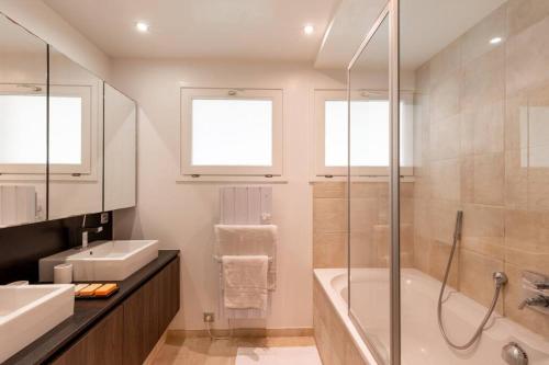 a bathroom with a shower and a tub and a sink at 2 bedrooms Duplex penthouse - Monaco border in Roquebrune-Cap-Martin