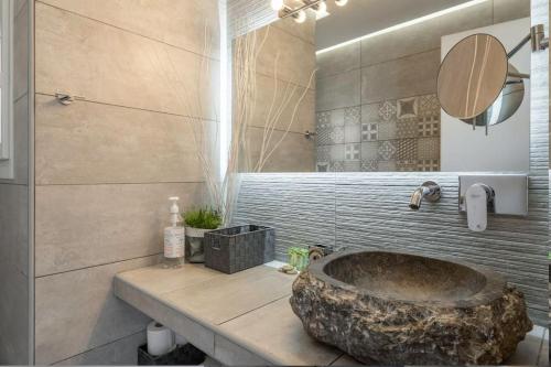 a bathroom with a large stone tub in a bathroom at Penthouse with views close to Monastiraki metro in Athens