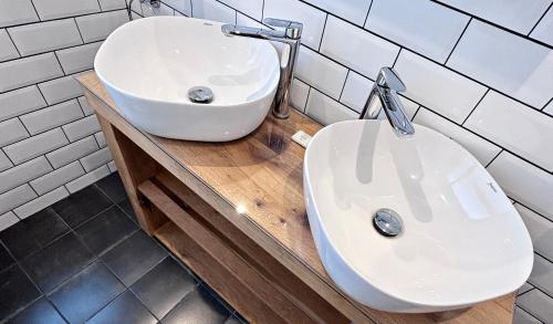 a bathroom with a white sink and a toilet at Lapwing Lodge with loch and mountain view in Crianlarich