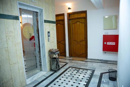 a hallway with two doors and a tile floor at Malik Dijlah Hotel in Baghdad