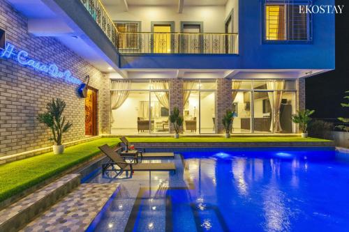 a house with a swimming pool at night at EKOSTAY - Casa De Reva in Lonavala