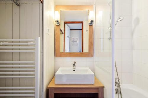 une salle de bain avec un lavabo, un miroir et une baignoire dans l'établissement Résidence Port du Crouesty - maeva Home - Appartement 2 pièces 5 personnes - Confort - vue Mer MAE-4764, à Arzon