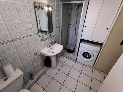une salle de bain avec un lavabo et une machine à laver dans l'établissement Résidence MAISONS DES SABLES 4 - 2 Pièces pour 6 Personnes 44, à Port-Leucate