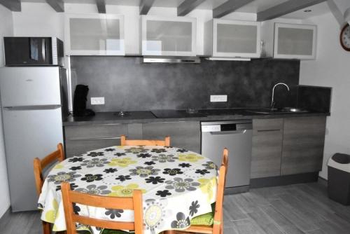 une cuisine avec une table et une cuisine avec une table et des chaises dans l'établissement Résidence Le Hameau Des Pecheurs - VILLA 3 PIECES 6 couchages PORT LEUCATE MAE-5824, à Port-Leucate