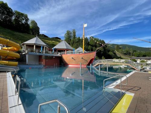 a cruise ship pool with a pirate ship on it at Landhaus Oberzinnegg in Saalbach Hinterglemm