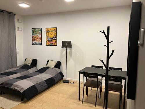 a bedroom with two beds and a desk and a table at Ku'damm cosy condo Berlin center in Berlin