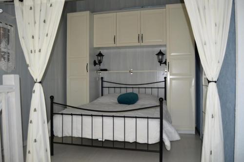- une chambre avec un lit noir et des rideaux blancs dans l'établissement Résidence Grande Bleue - VILLA T1 CAB MEZZ 5 couchages PORT LEUCATE MAE-6184, à Port-Leucate