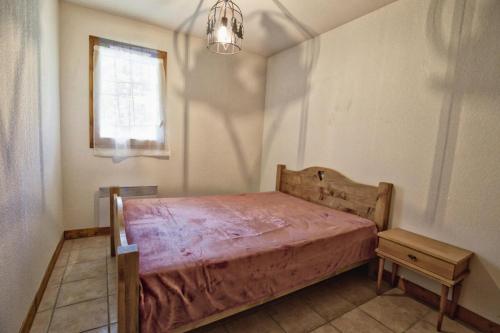 a bedroom with a bed and a window at Résidence Le Schuss 1 - 3 Pièces pour 6 Personnes 34 in Notre-Dame-de-Bellecombe