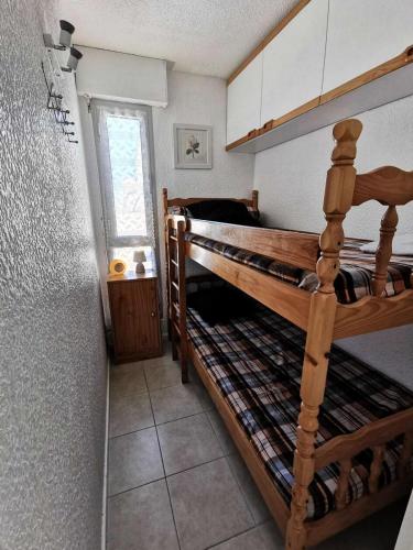 une chambre avec deux lits superposés et une fenêtre dans l'établissement Residence De La Plage - APPT T2 CAB OU MEZZ 6 couchages PORT LEUCATE. Réf: 1RP_593 MAE-6214, à Port-Leucate