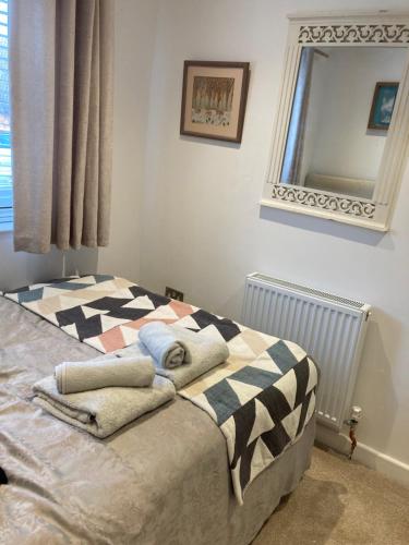 a bedroom with a bed with towels on it at House on the corner in Thame