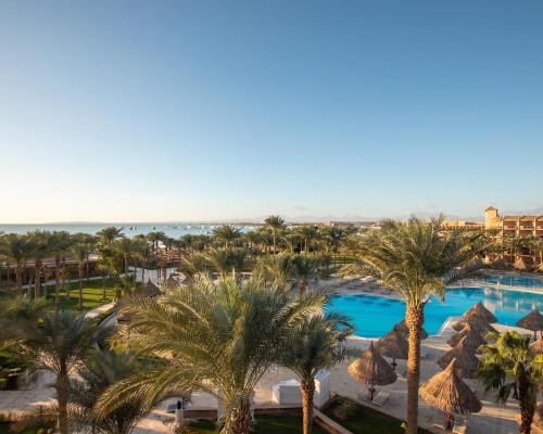 an aerial view of a resort with palm trees and a pool at Siva Grand Beach in Hurghada