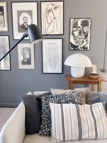 a living room with a couch and pictures on the wall at Hönö Sjöbodar in Hönö