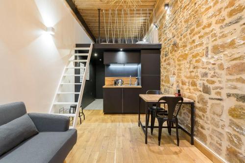 a living room with a couch and a table at Hamac Suites - studio Ainay 1 - hyper centre Lyon in Lyon