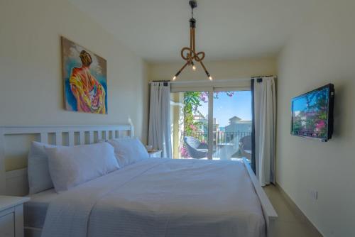 a bedroom with a white bed and a window at VESTA - Sahl Hasheesh Residence in Hurghada