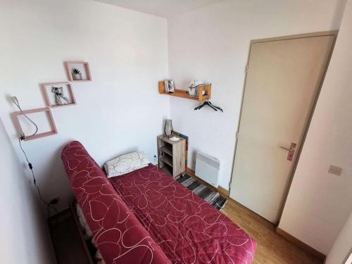 - une chambre avec un grand lit rouge dans l'établissement Résidence Le Cezelly - 2 Pièces 4 couchages PORT LEUCATE. Réf: 4CEZ_23A MAE-7044, à Port-Leucate