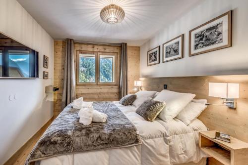 une chambre avec un grand lit et une télévision dans l'établissement Résidence Les Nouveaux Alpages - Appartement 4 avec accès au SPA inclus MAE-8234, à Champagny-en-Vanoise