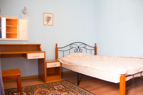 a bedroom with two beds and a desk at Apple tree in Almaty
