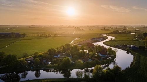 arial view of a village with a river at Tiny house - optioneel met hottub in Dokkum