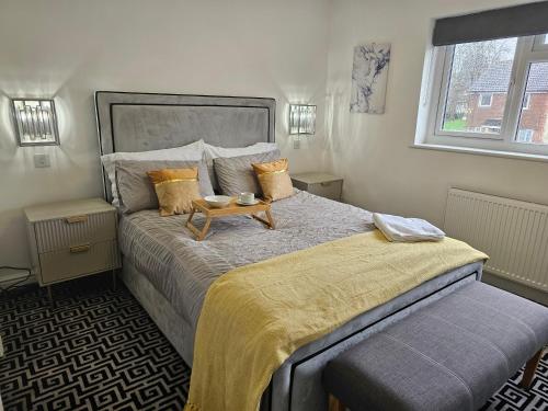 a bedroom with a large bed with a table on it at Vienna Orpington in Orpington