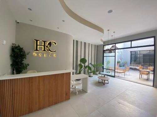 a hotel lobby with a htec salon sign on the wall at Hotel Caseros Salta in Salta