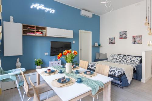 un soggiorno blu con tavolo e sedie di OurJoy Condo, free parking, AC, strong WiFi - M Gioia47, Central Station, Porta Nuova, Milan a Milano