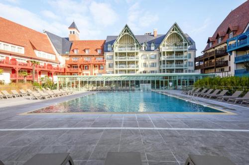 une cour avec piscine dans un immeuble dans l'établissement Résidence Presqu'Ile de la Touques - Appartement 3 pièces 6 personnes Prestige MAE-8822, à Deauville