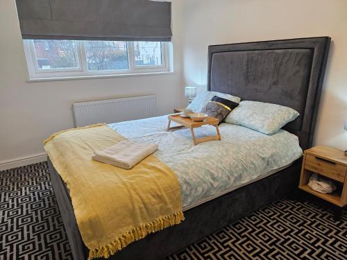 a bedroom with a bed with a table on it at Vienna Orpington in Orpington