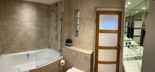 a bathroom with a bath tub and a shower at 7a in London