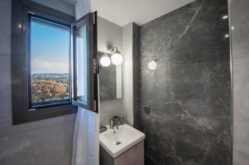 a bathroom with a sink and a window at E&A luxury apartment with sea view in Rhodes Town