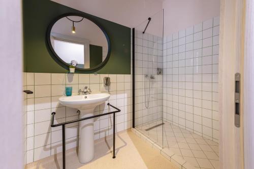 a bathroom with a sink and a mirror at Stil Old Town Boutique Hotel in Bucharest