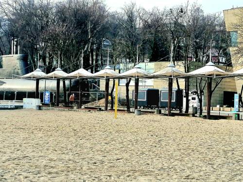 a group of umbrellas on a sandy beach at Gdynia Batory in Gdynia
