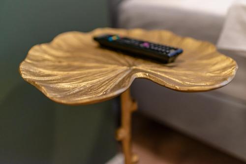 a remote control sitting on top of a wooden table at Stil Old Town Boutique Hotel in Bucharest