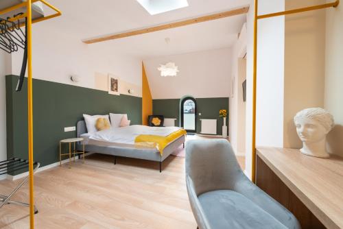 a bedroom with a bed and a chair in it at Stil Old Town Boutique Hotel in Bucharest
