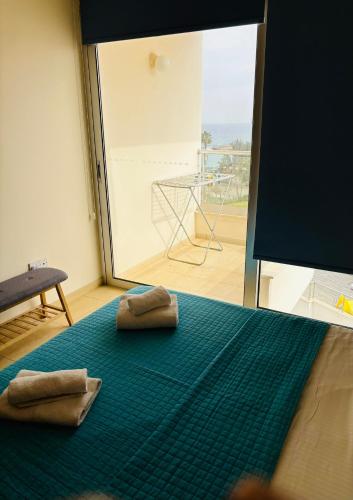 two towels are sitting on a blue rug on a room at PALLINIO COURT 402 Fig Tree Bay- Protaras Beach, IASONOS STR 7A in Protaras